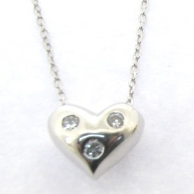 solid silver heart pendant with 3 diamonds embeded on a 18 inch gold chaine