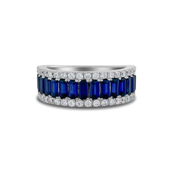 A sterling silver half eternity band with baguette and brilliant-cut stones, prong-set in a refined design with rhodium plating. Available with lab-created diamond simulants or blue sapphire simulant baguettes.